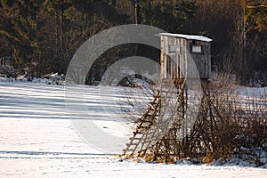 Winter frozen landscape with hunting tower on highland