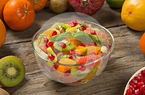 Winter fruit salad with ingredients on an old rustic wooden table. Selected focus.