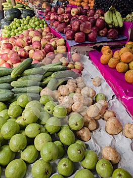 Winter fruits kept in retail storefront for sale in bengal india. kul or indian jujube or indian plum, cucumber and other seasonal