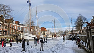 Winter fun in the city Dokkum on the canals in the Netherlands