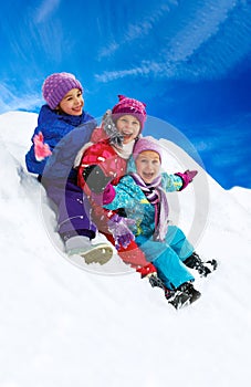 Winter fun, happy children sledding at winter time