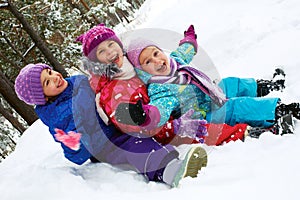 Winter fun, snow, children sledding at winter time