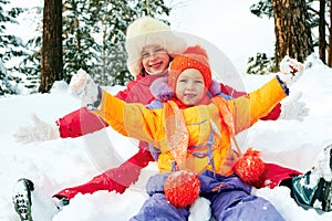 Winter fun, snow, happy children sledding at winter time