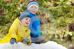 Winter fun with snow two smiling little boys