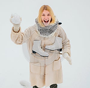 Winter Funny smiling woman portrait. Beautiful woman enjoying first snow. Winter funny woman with ice-skating. Happy