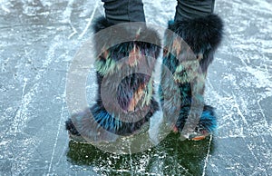 Winter fur shoes on the ice surface