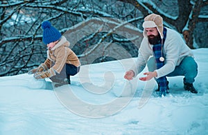 Winter game for happy family. Christmas background. Happy loving family. Father and son in snow.