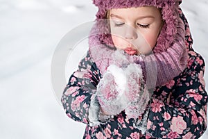 Winter, games, family, childhood concepts - close-up portrait authentic little preschool minor girl in pink hat warm