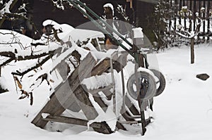 Winter garden covered with snow, small carriage