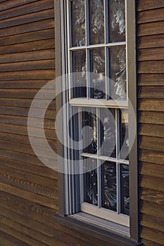 Winter Garland Inside Windowpanes and Wood Siding