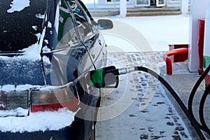 In the winter at the gas station refuel the car