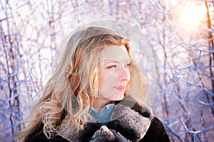 Winter girl behind snow tree