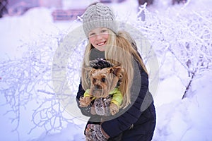 Winter girl blowing snow. Beauty Joyful Teenage Model Girl having fun in winter park. Beautiful girl laughing outdoors. Enjoying n