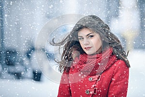 Winter. Girl brunette capless smiles on the background of snow. Close-up. hair develops photo