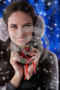 Winter Girl Holding a Christmas Decoration