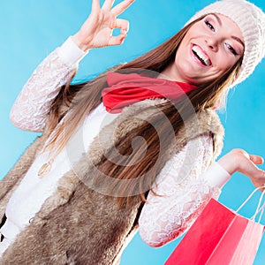 Winter girl with red paper shopping bag