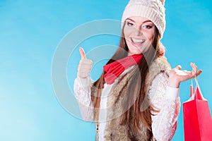 Winter girl with red paper shopping bag