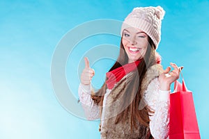 Winter girl with red paper shopping bag