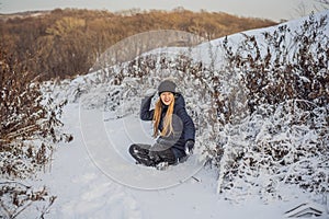 Winter girl throwing snowball at camera smiling happy having fun outdoors on snowing winter day playing in snow. Cute