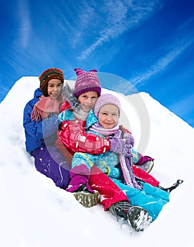 Winter , happy children sledding at winter time