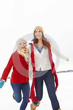 Winter, happy and lesbian couple outdoor in snow on romantic vacation, adventure or holiday. Love, smile and queer women