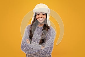 Winter hat. Cold season concept. Winter fashion accessory for children. Teen girl wearing warm knitted hat. Happy