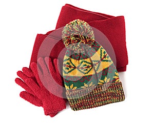 Winter hat, red scarf and gloves isolated on white background
