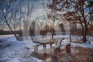 Winter hdr sunset sky landscape picnic area outdoor weekend holiday travel. BBQ concept with table and bench. outdoor