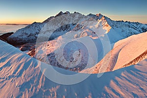 Winter High Tatras mountain range panorama with many peaks and clear sky from Belian Tatras. Sunny day on top of snowy mountains.