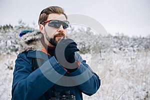 Winter Hiker in Blue Anorak Rubbing His Hands