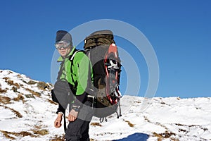 Winter hiking in the mountains on snowshoes with a backpack and tent.