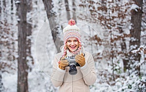 Winter hobby. Taking stunning winter photos. Enjoy beauty of snow scenery through photos. Woman photographer with