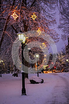 Winter holiday atmosphere in Riga park with lanterns