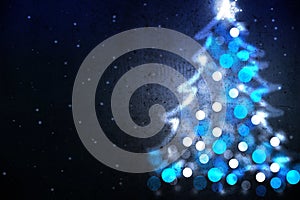 Winter holiday background with blue Christmas tree shape from lights