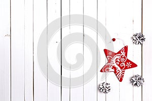 Winter holiday background with red star and snow painted pine co