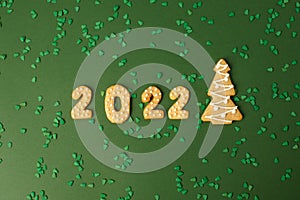 Winter Holiday banner set of gingerbread on natural green background - Number Happy New Year 2022, xmas tree with sprinkles, Merry