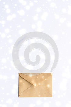 Winter holiday blank paper envelopes on marble with shiny snow flatlay background, love letter or Christmas mail card design