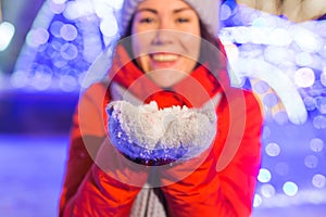 Winter holiday season. Christmas, New Year concept. Funny happy woman spend time having fun near illuminated and