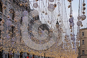 Winter holiday street with luminous festoons. Large Christmas ball from the garland glow, Christmas