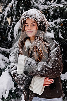 Winter holiday travel, Christmas day, New Year, beautiful happy woman portrait at snowy forest, nature woods, ski resort, leisure