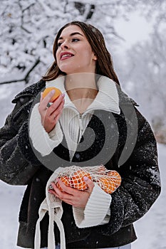 Winter holiday travel, Christmas day, New Year, beautiful happy woman portrait at snowy forest, nature woods, ski resort, leisure