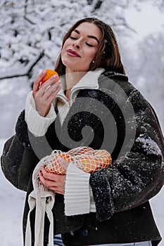 Winter holiday travel, Christmas day, New Year, beautiful happy woman portrait at snowy forest, nature woods, ski resort, leisure