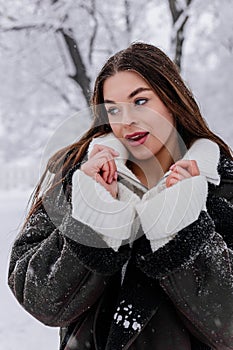 Winter holiday travel, Christmas day, New Year, beautiful happy woman portrait at snowy forest, nature woods, ski resort, leisure