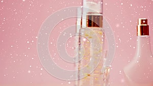 Winter holidays beauty product sale, make-up and cosmetics product promotion on pink background with snow and glitter