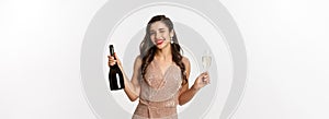 Winter holidays celebration concept. Beautiful woman enjoying Christmas and New Year party, drinking champagne and