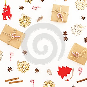 Winter holidays composition. Christmas gifts, wooden decorations and candy canes on white background. Flat lay, top view, copy spa