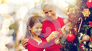 Grandmother and granddaughter at christmas tree