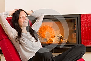 Winter home fireplace woman relax red armchair