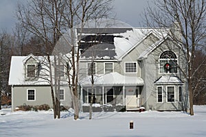 Winter home with solar panels and Christmas wreath