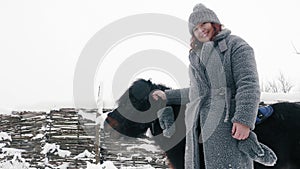 winter horse ride. horseback riding at winter. Happy, smiling woman , holds a little pony by the bridle. family